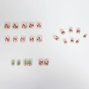 Christmas press-on nails set with festive green tree and red light string patterns