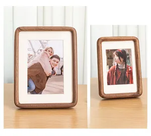 Detail of solid wood walnut photo frame with rounded corners and white inner matting