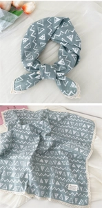 Detail of grey-blue cotton linen scarf with geometric patterns and white lace edges