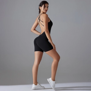 Detail view of black cross-back sports romper with high-elastic compression fabric