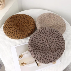 Detailed view of leopard print wool berets in brown, taupe and beige soft textures