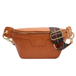 Brown leather crossbody chest bag with colorful geometric woven strap and gold zipper
