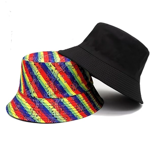Reversible bucket hat featuring black side and rainbow paisley pattern for outdoor sun protection