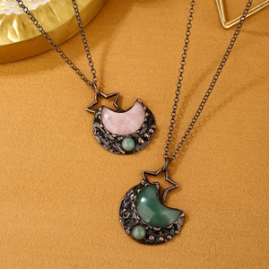 Detail of vintage star and moon necklaces with rose quartz and green aventurine pendants