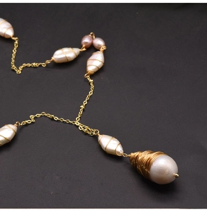 Detailed shot of handmade baroque pearl necklace with gold wire wrapping craft