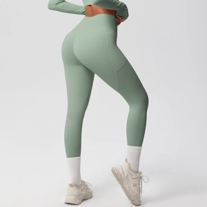 Detail view of high waisted sage green yoga leggings with side pockets and lifting seams