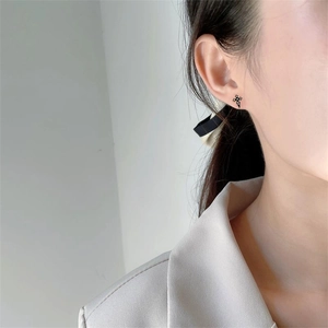 Minimalist S925 sterling silver black cross stud earrings on ear for women and men