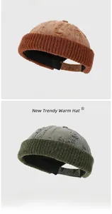 Close-up of distressed knit beanies in brown and olive green with vintage hole details