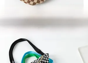 Detail showing checkered fanny pack with colorful adjustable straps in various bright colors