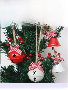 Detail of Christmas tree bells with star cutouts, plaid bows and red berry accents
