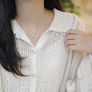 Elegant gold S925 sterling silver double-layer bow necklace on a model's neck