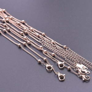 Detail showing rose gold beaded 304 stainless steel chain with secure lobster clasps