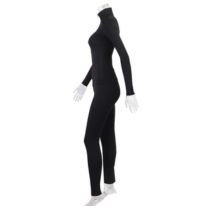 Side view of black athletic set featuring zip-up stand collar jacket and fitted leggings