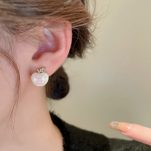 Elegant apple-shaped stud earrings with iridescent pearl finish and diamond-set leaves