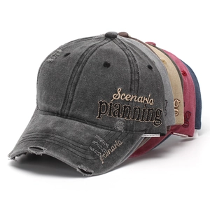 Macro detail of distressed washed cotton baseball caps with Scenario Planning embroidery