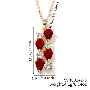 Detail showing gold bar necklace dimensions with pear-shaped red gems and clear crystals