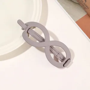 Macro shot of large matte grey infinity hair claw clip with smooth Morandi finish