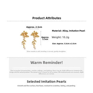 Detailed view of leaf earrings showing dimensions 5.5cm by 2.5cm and pearl accents