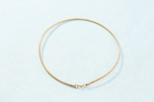 Detailed view of the gold stainless steel snake bone chain with secure metal clasp