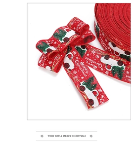 Red Christmas ribbon roll with white truck and green tree pattern with festive bow