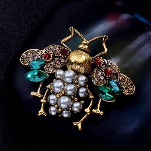 Baroque bee brooch with grey pearls and multi-colored rhinestones on gold wings