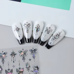 Detail of 3D holographic silver butterfly and gothic cross nail stickers on French tips