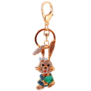 Sparkling rhinestone rabbit keychain with blue dress and green ball in gold finish