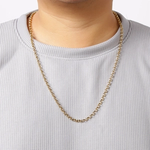 Close-up of golden stainless steel pearl chain necklace worn on a model's neck