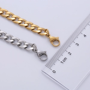 Macro detail of 7mm stainless steel NK chain bracelet showing width measurement with a scale