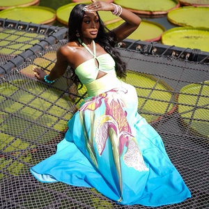 Detail of the halter neck hollow cut-out design and gradient iris print on the maxi dress
