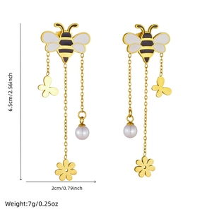 Golden tassel earrings featuring bee, butterfly, flower motifs and a white pearl drop