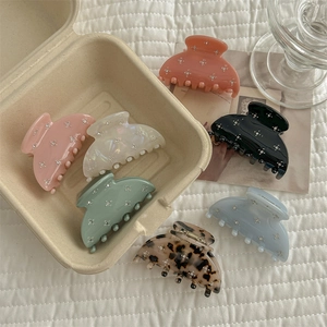Set of crystal French hair claws in various colors like marble and ice cream tones