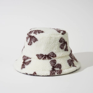 Plush lamb wool bucket hat featuring retro brown pattern on white for winter warmth