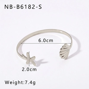 Detail of silver stainless steel cuff bangle featuring carved starfish and seashell motifs