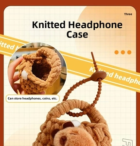 Close-up of brown knitted bear pouch for earphones and coins with drawstring detail