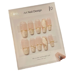 Elegant nude press-on nails set with marble texture, gold lines, and pearl accents