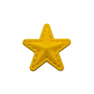 Close-up of yellow star PVC patch with detailed stitching texture on white background