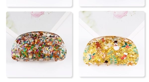 Detail of resin Christmas hair clips with sequins, snow graphics and festive patterns