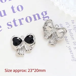 Detailed silver bow pendant with black heart stones and 23x20mm dimensions