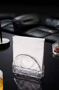 Detail view of crystal glass tissue holder with embossed heart on black marble table