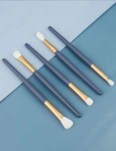 Detailed view of 5-piece professional blue eye makeup brushes with white fiber bristles