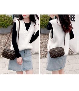 Street style shot of brown monogram crossbody camera bag with metallic logo detail