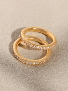 Macro shot of two stacked gold plated eternity rings with sparkling 5A cubic zirconia stones