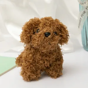 Fluffy brown poodle plush toy dog with soft curly fur on a clean white fabric background
