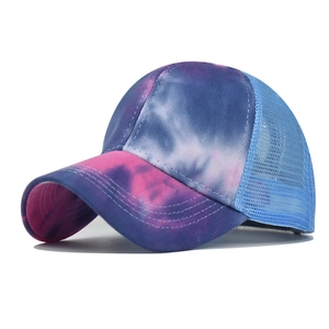 Detailed view of tie-dye sun visor hat with blue mesh back and precision stitching
