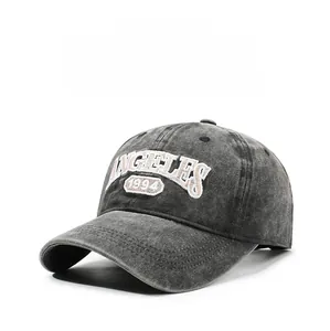 Detail of embroidered ANGELES 1994 text on washed gray cotton baseball cap