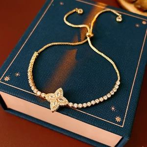 Detailed view of gold adjustable bracelet featuring a shimmering zircon flower charm