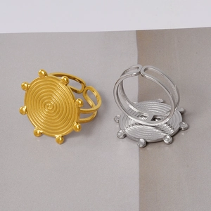 Macro detail of gold and silver vortex rings with round beaded edges and spiral patterns