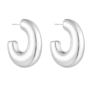Close-up of polished silver tubular G-shaped earrings with a smooth metallic finish