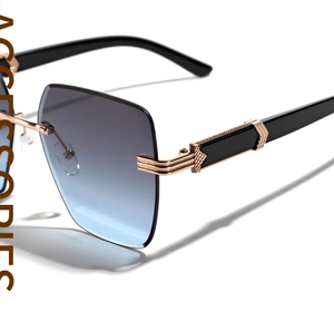 Close-up of golden metal hinges with embossed texture on rimless gradient sunglasses